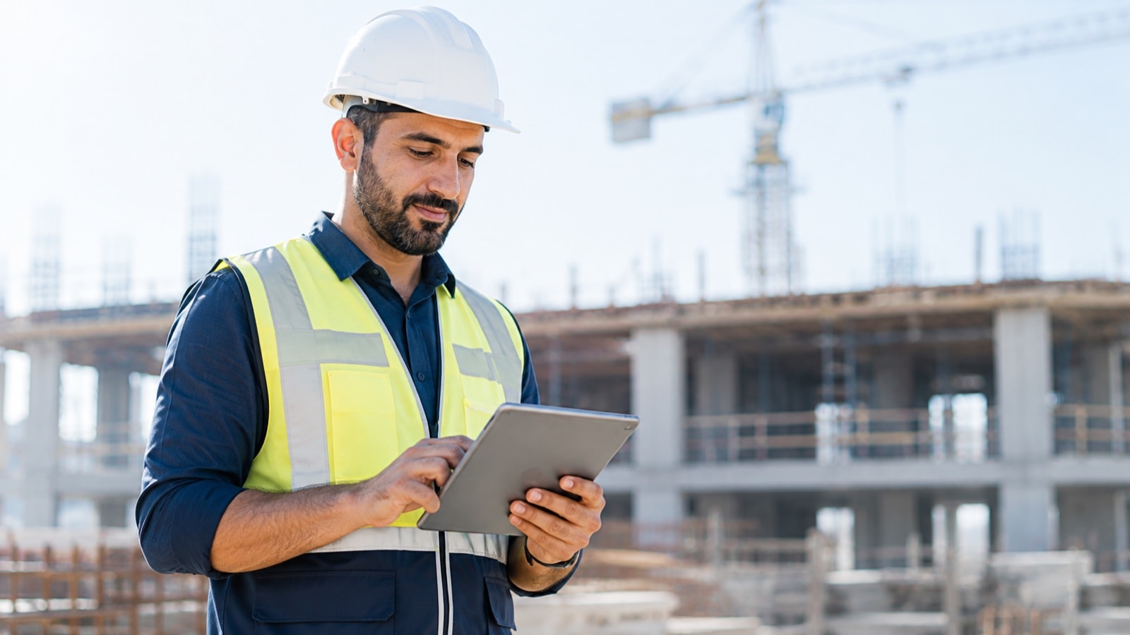 A contracting engineer reviewing progress at a construction site